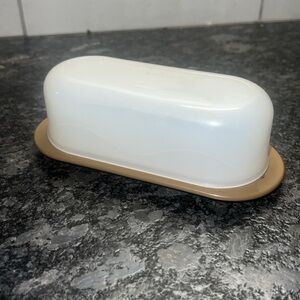 Vintage Tupperware tan butter dish with lid. In very good used condition.